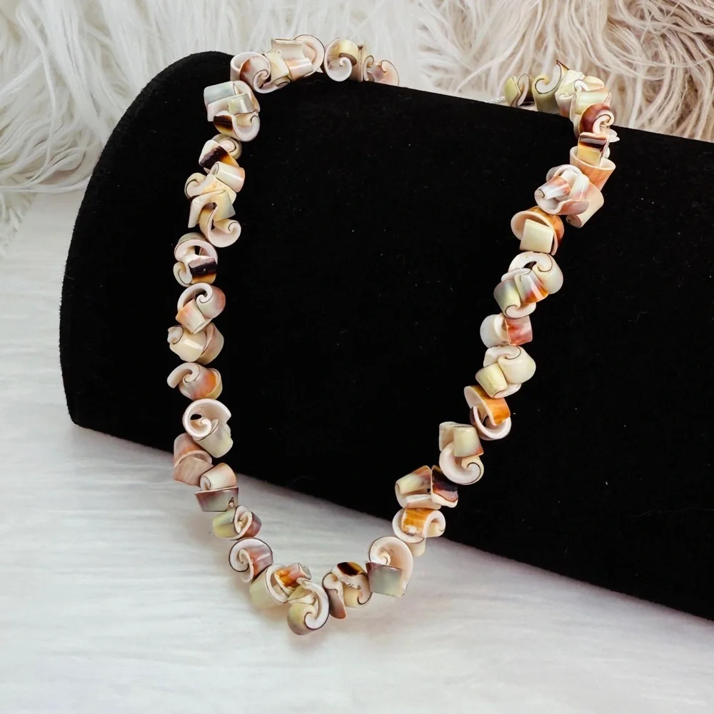 Beautiful vintage necklace composed of curly-cut conch shell beads individually